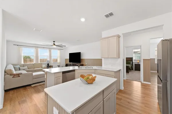 a kitchen with a refrigerator a stove and a sink