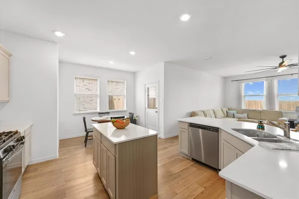 a kitchen with stainless steel appliances granite countertop a sink stove and refrigerator