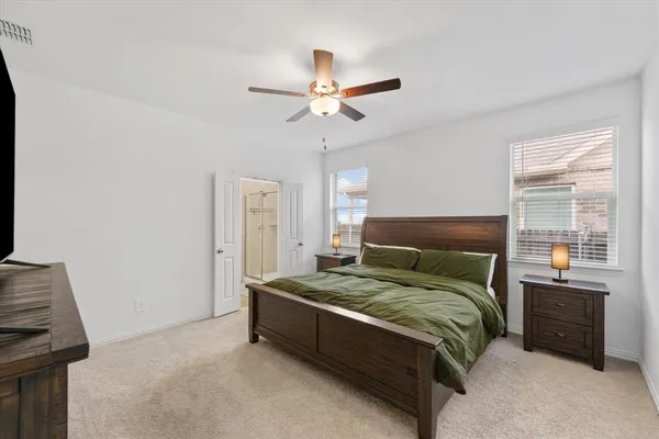 a bedroom with a bed and a window