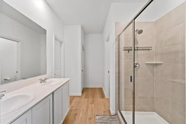 a spacious bathroom with a shower and a sink