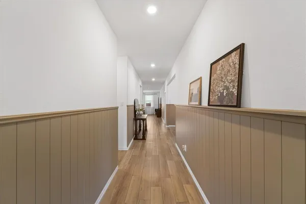 a view of a hallway with wooden floor