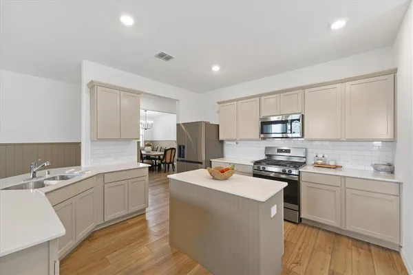 a kitchen with a sink stove and cabinets