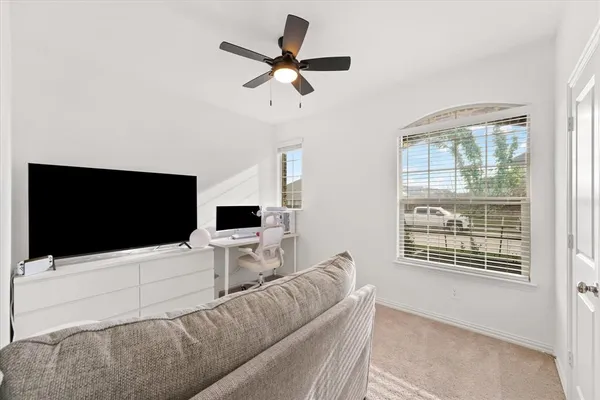 a living room with a flat screen tv and a window