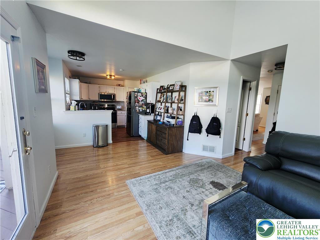 237 Ridings Circle Macungie, PA 18062 - Photo 25 of 70 Warm hardwood floors anchor this open-concept layout transitioning from living space into the kitchen.