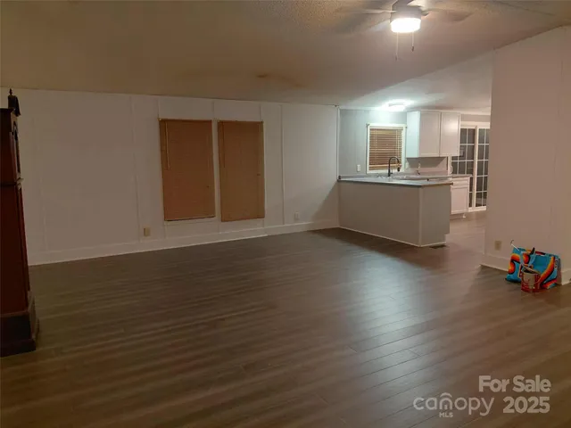 a view of a kitchen with wooden floor and a sink