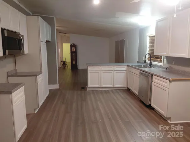 a kitchen with a sink microwave and refrigerator