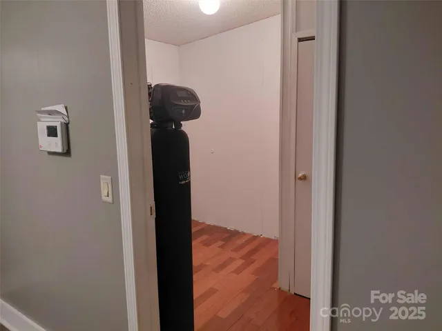 a view of hallway with wooden floor