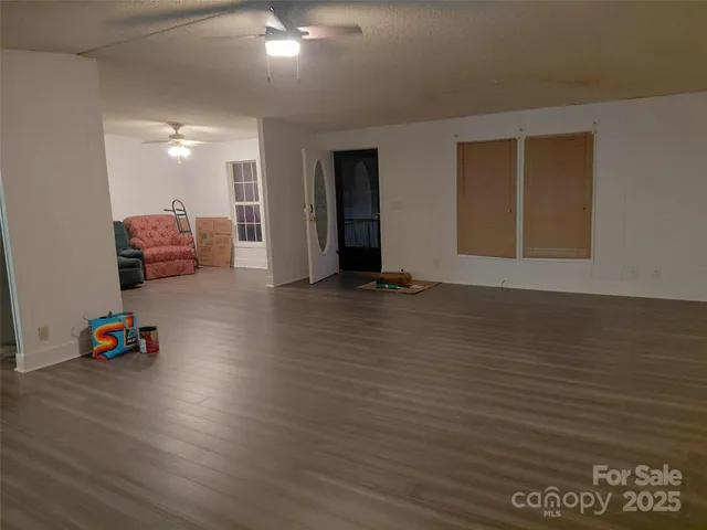 a view of room with furniture and wooden floor