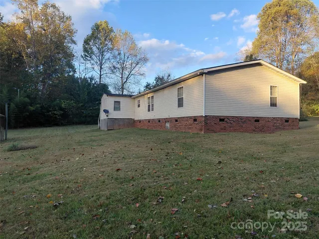 a view of a white house with a yard