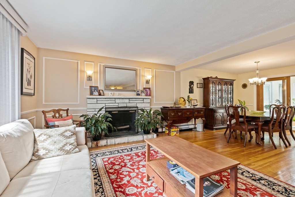 381 Lincoln Street Lexington, MA 02421 - Photo 11 of 35 a living room with furniture a fireplace a rug and a window
