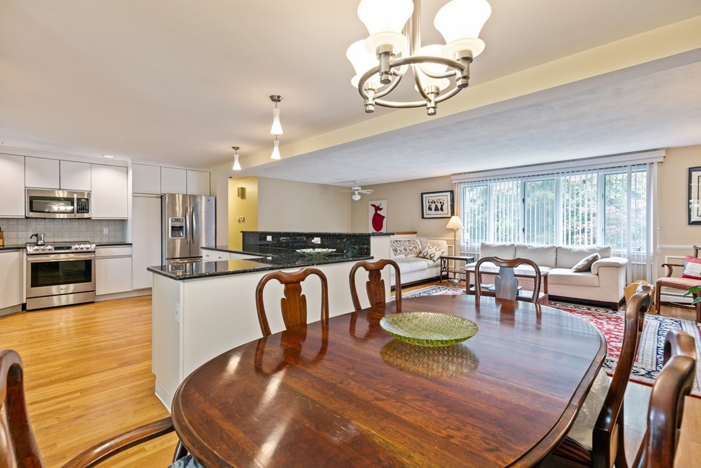 381 Lincoln Street Lexington, MA 02421 - Photo 13 of 35 a dining room with furniture a kitchen view and wooden floor