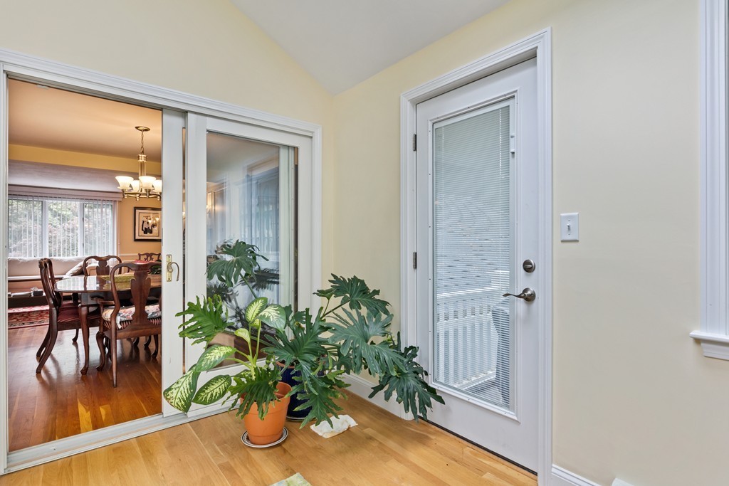 381 Lincoln Street Lexington, MA 02421 - Photo 14 of 35 a dining room with furniture potted plants and wooden floor