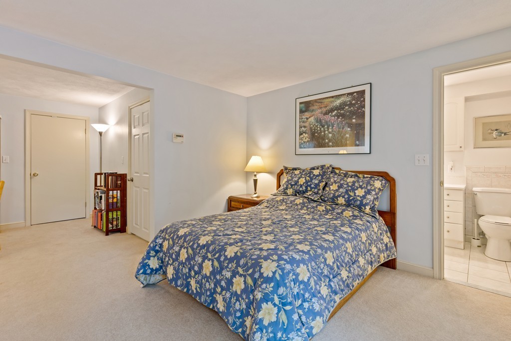 381 Lincoln Street Lexington, MA 02421 - Photo 21 of 35 a bedroom with a bed and a lamp