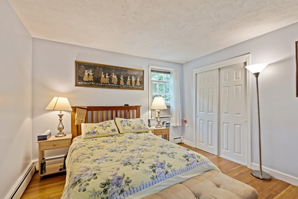 381 Lincoln Street Lexington, MA 02421 - Photo 25 of 35 a bedroom with a bed and a lamp on dresser