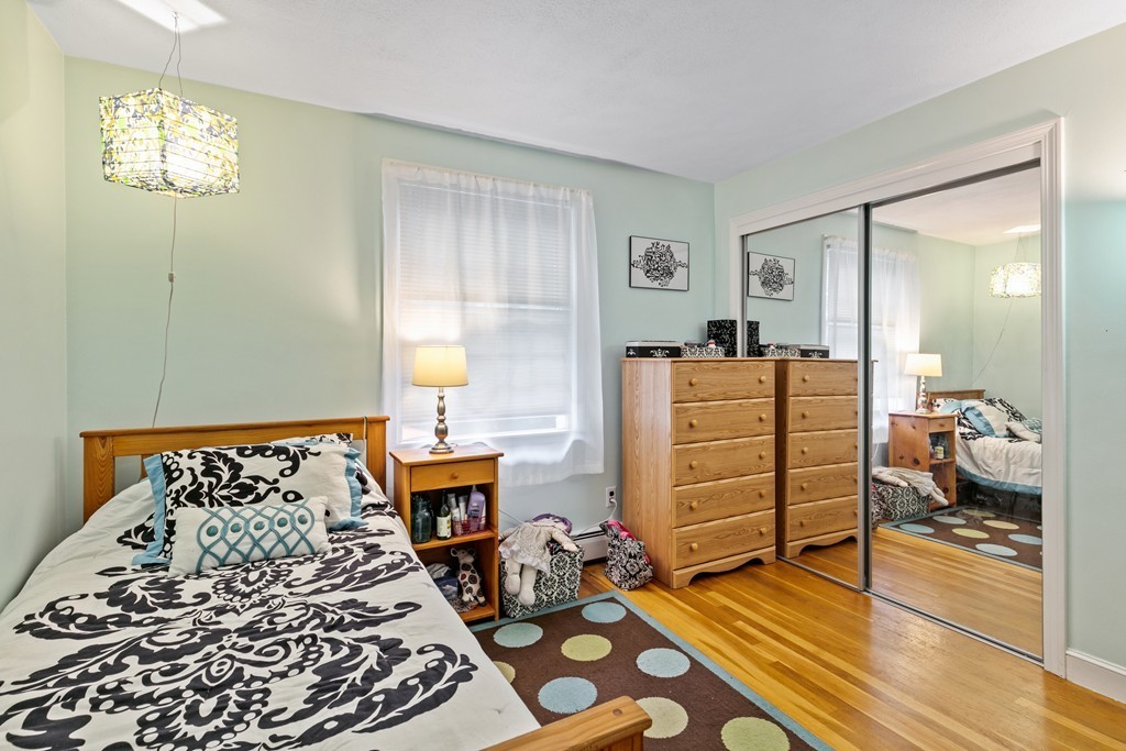 381 Lincoln Street Lexington, MA 02421 - Photo 27 of 35 a bed room with a bed and a chair