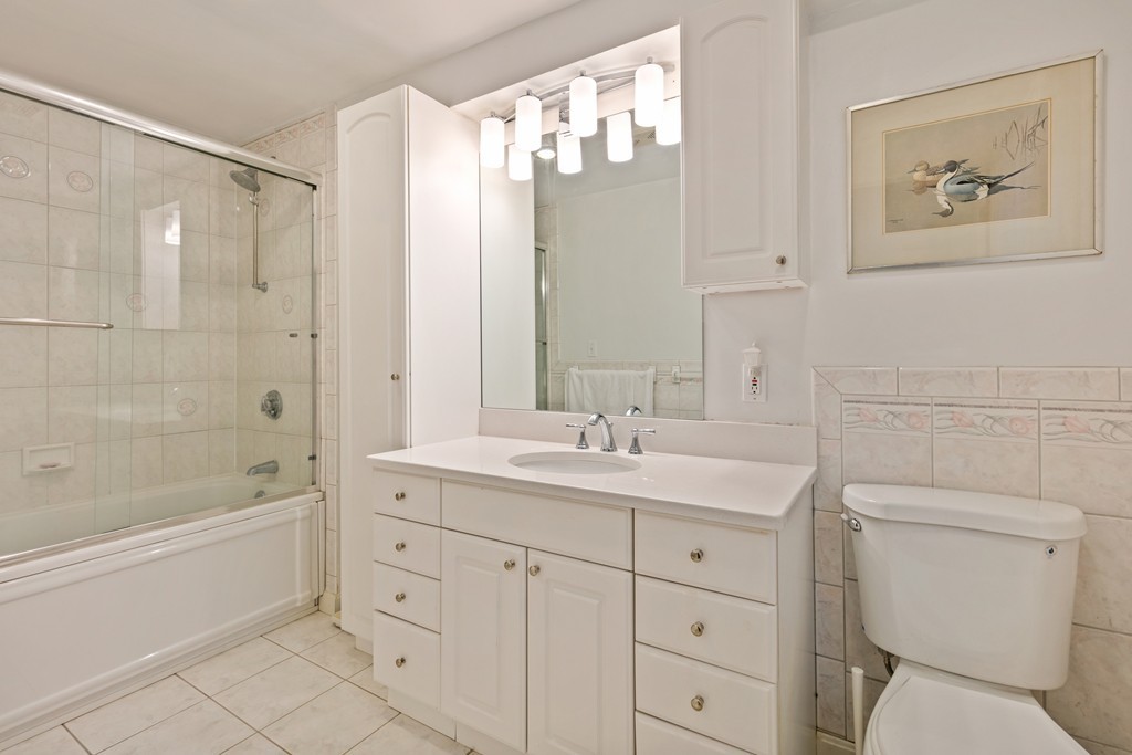 381 Lincoln Street Lexington, MA 02421 - Photo 32 of 35 a bathroom with a granite countertop sink a toilet and bathtub