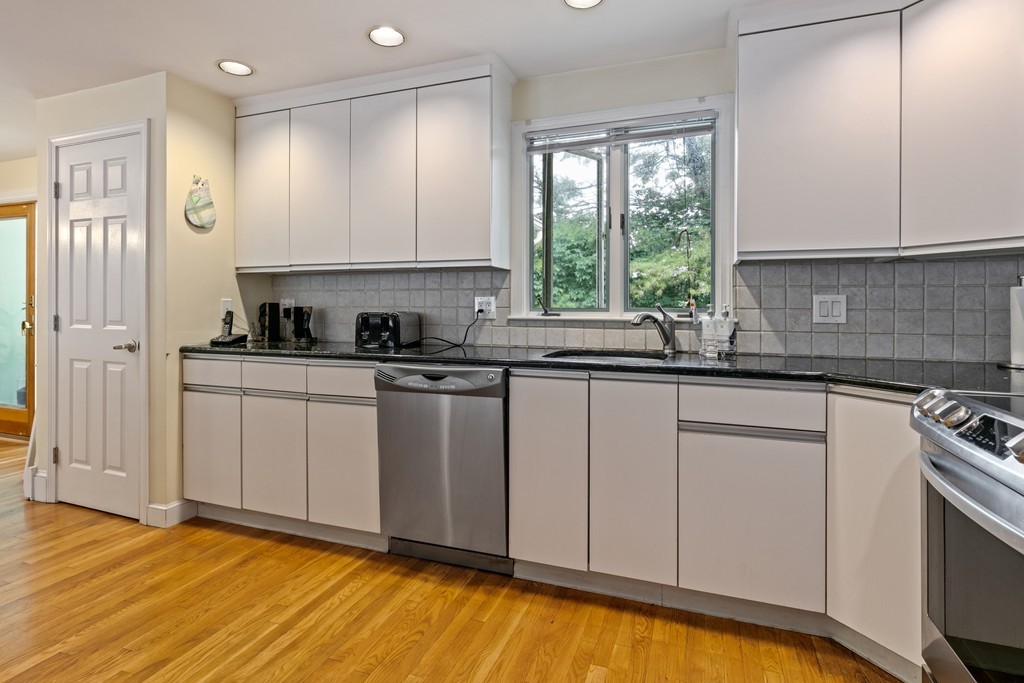 381 Lincoln Street Lexington, MA 02421 - Photo 6 of 35 a kitchen with a sink cabinets and window