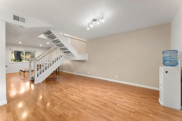 a view of entryway and hall with wooden floor