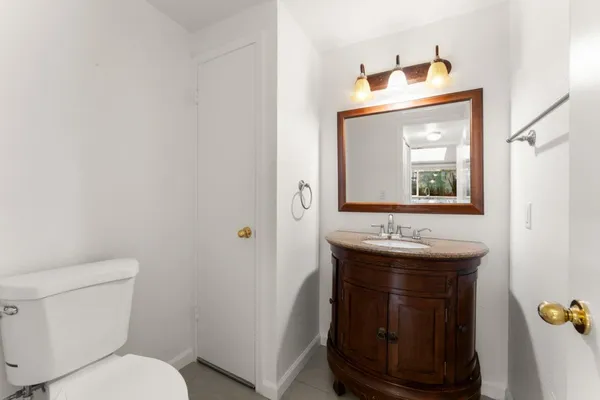 a bathroom with a toilet sink and mirror