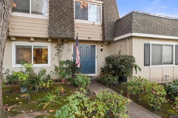 a view of a house with potted plants