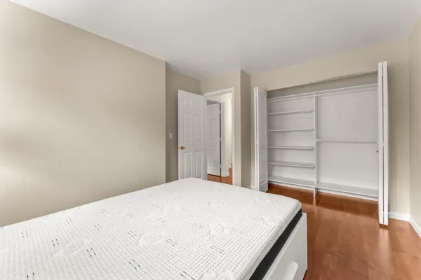 a bedroom with a bed and a lamp