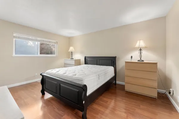 a bedroom with a bed and a table