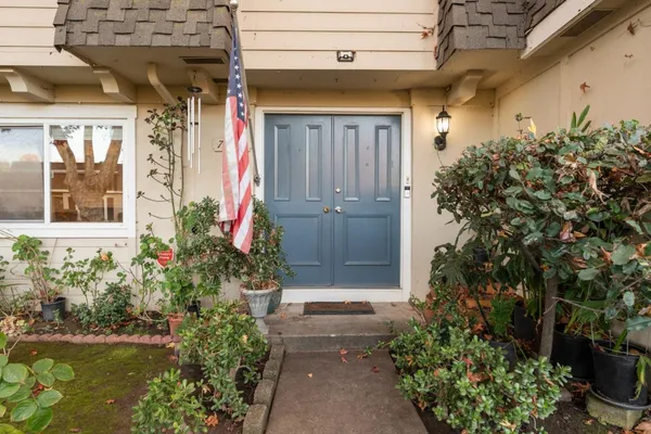 a front view of a house with a yard garage and outdoor seating