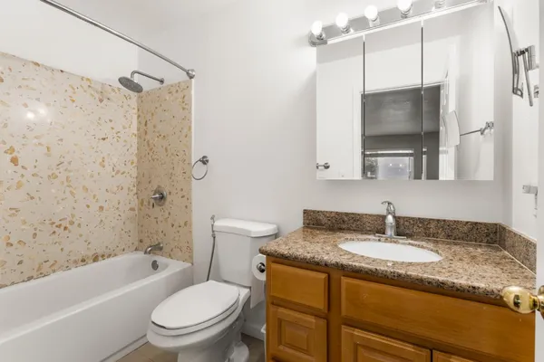 a view of a house with a yard balcony and sitting area