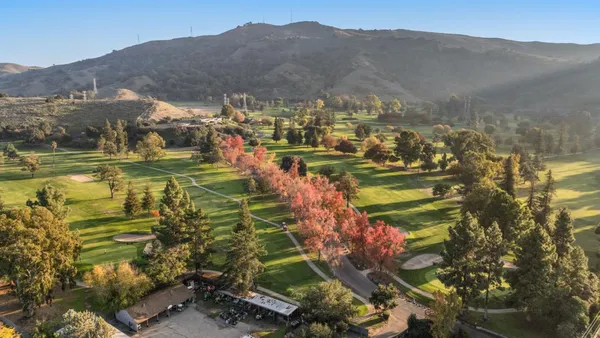 an aerial view of a house with a yard