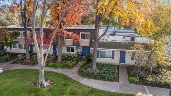 an aerial view of a house with swimming pool and sitting area