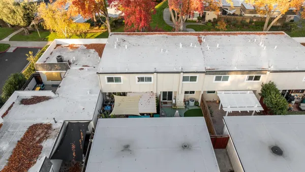 an aerial view of residential houses with city view