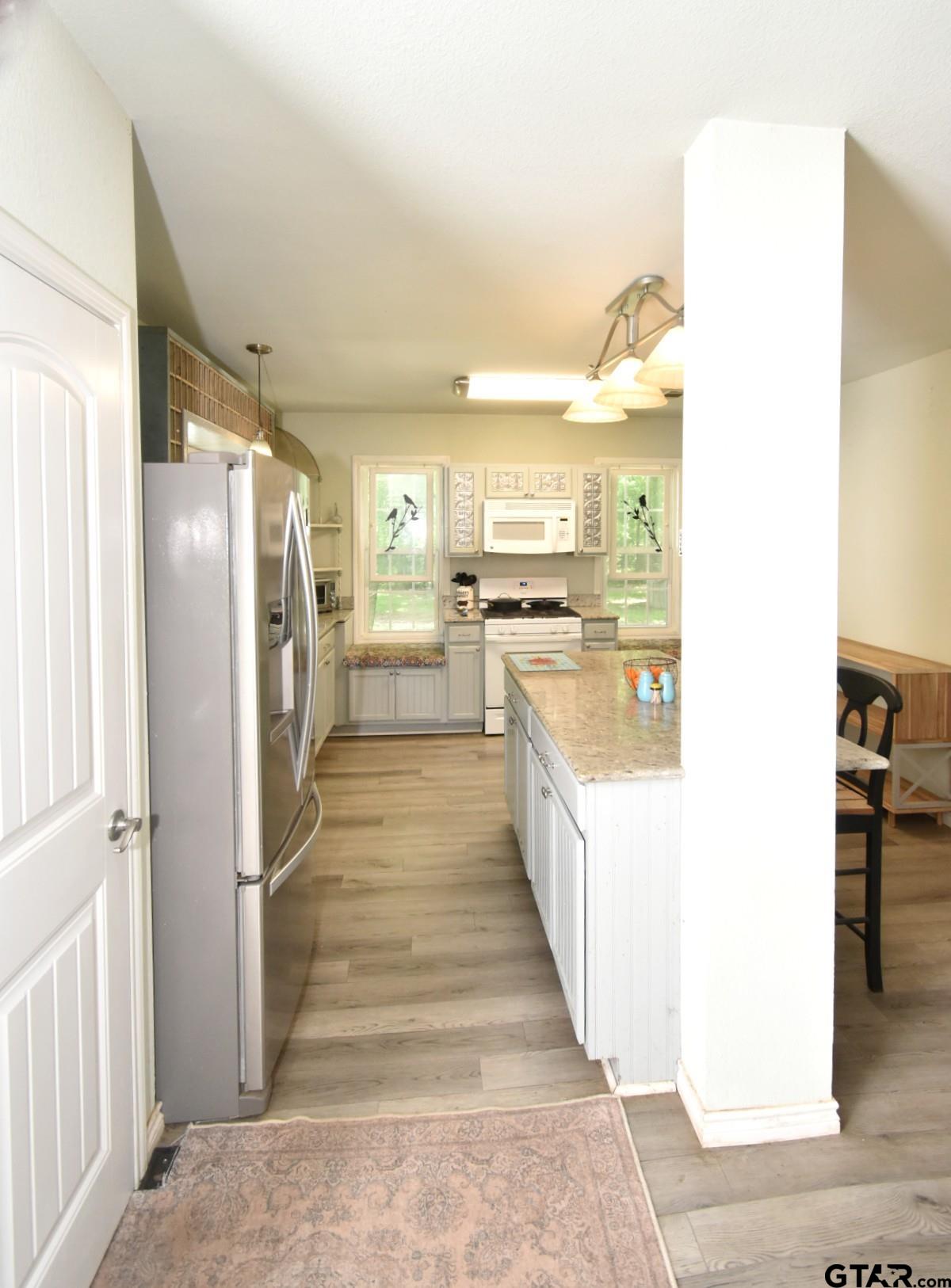 370 Spur 514 Yantis, TX 75497 - Photo 23 of 38 a kitchen with refrigerator and cabinets