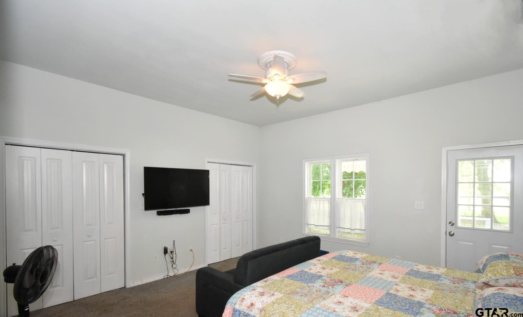 370 Spur 514 Yantis, TX 75497 - Photo 25 of 38 a bedroom with a bed and a flat screen tv