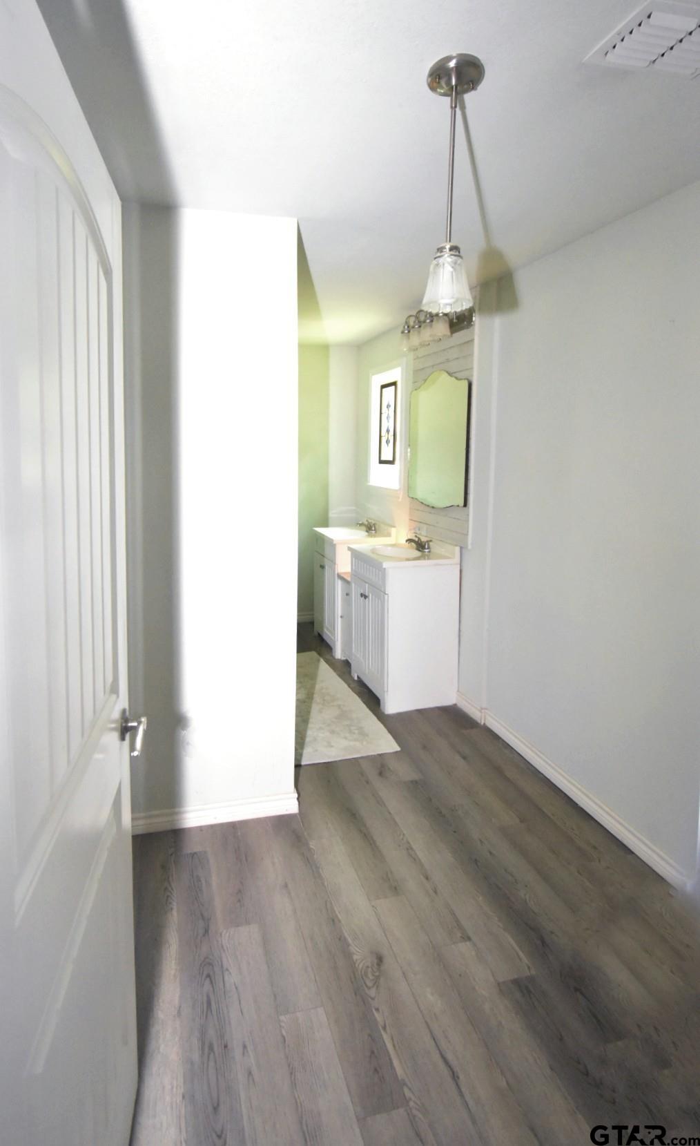 370 Spur 514 Yantis, TX 75497 - Photo 27 of 38 a bathroom with a sink and a mirror