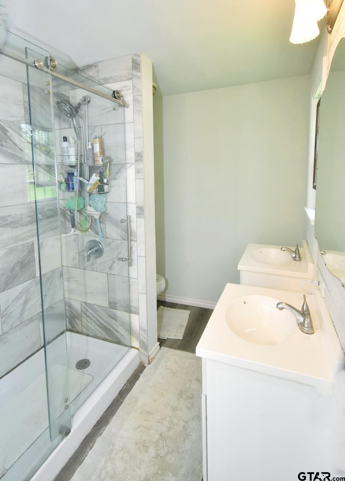 370 Spur 514 Yantis, TX 75497 - Photo 31 of 38 a bathroom with a shower and a sink