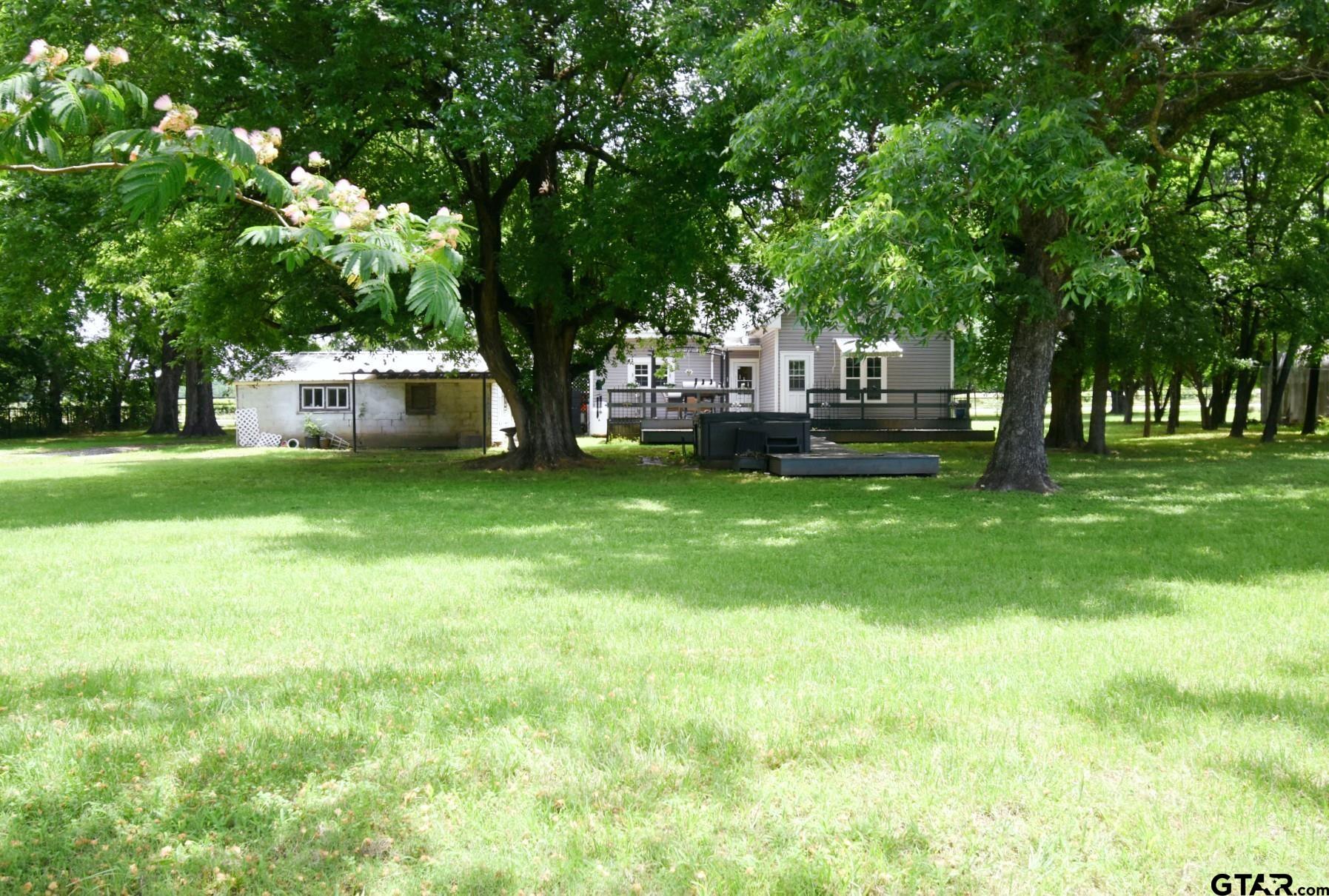 370 Spur 514 Yantis, TX 75497 - Photo 5 of 38 a view of a house with a big yard and sitting area