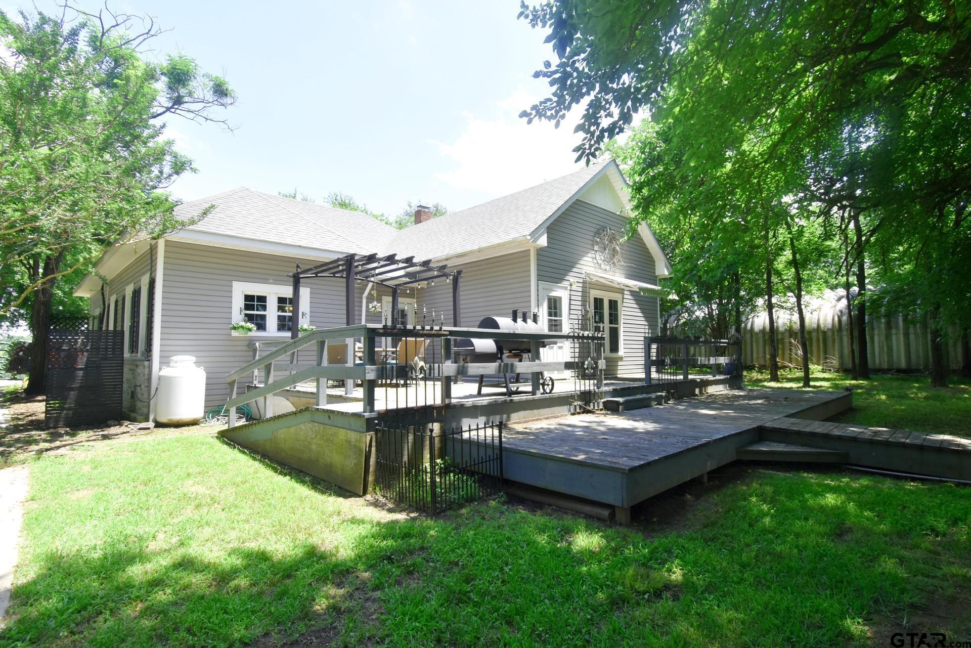 370 Spur 514 Yantis, TX 75497 - Photo 6 of 38 a view of a house with a backyard porch and sitting area