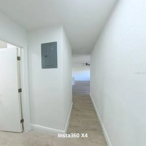 an empty room with windows and entrance