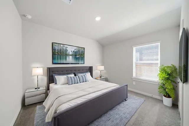 a bedroom with a bed and a window