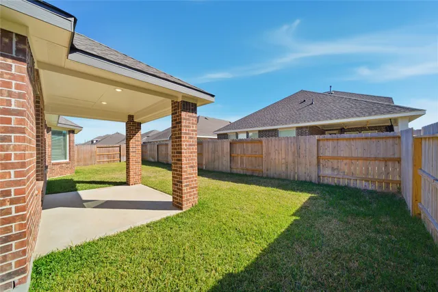 a view of a backyard with a garden and deck