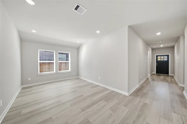 wooden floor in an empty room with a window