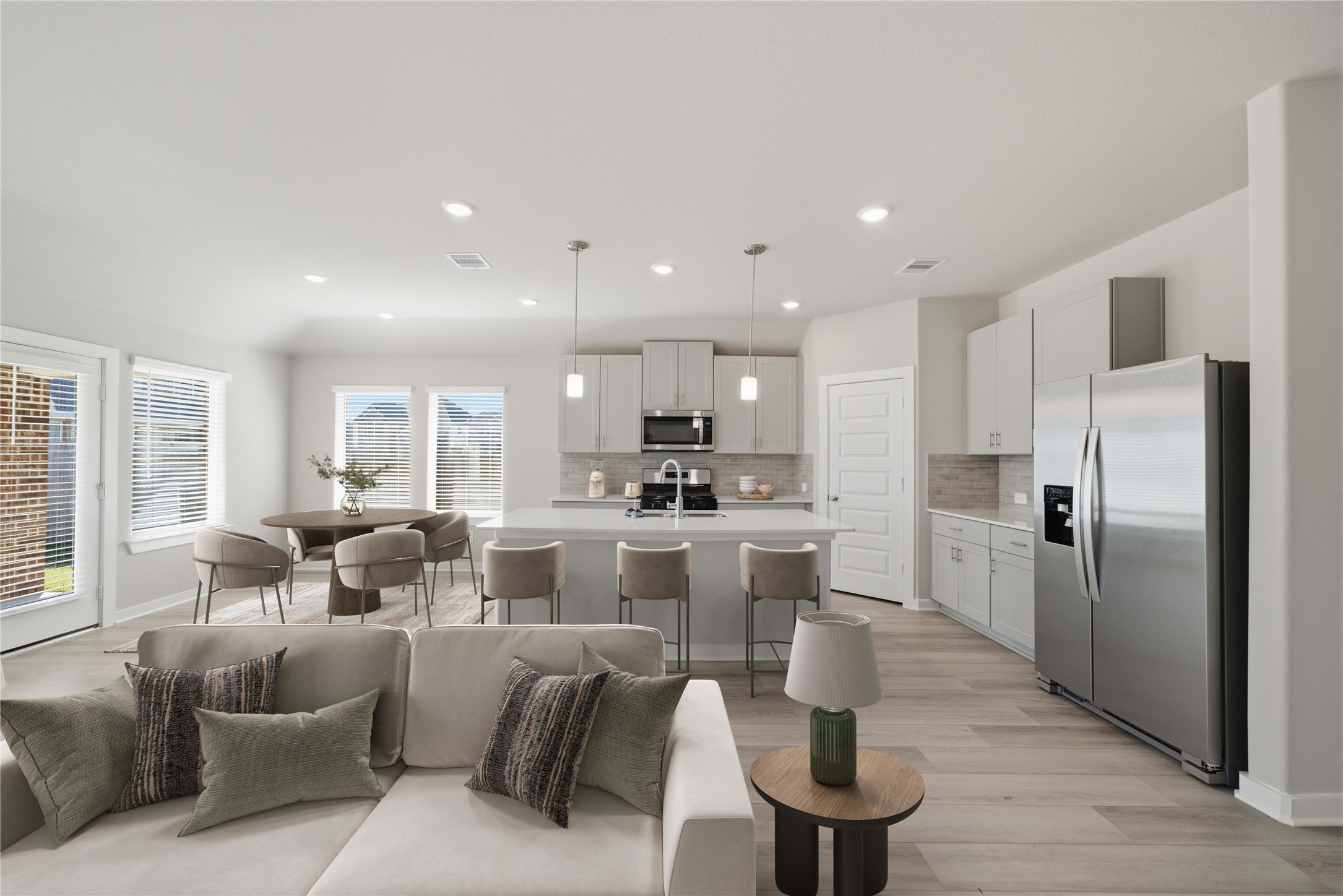 2606 Good Morrow Drive Rosenberg, TX 77471 - Photo 5 of 23 a large living room with stainless steel appliances kitchen island granite countertop a couch a dining table and chairs