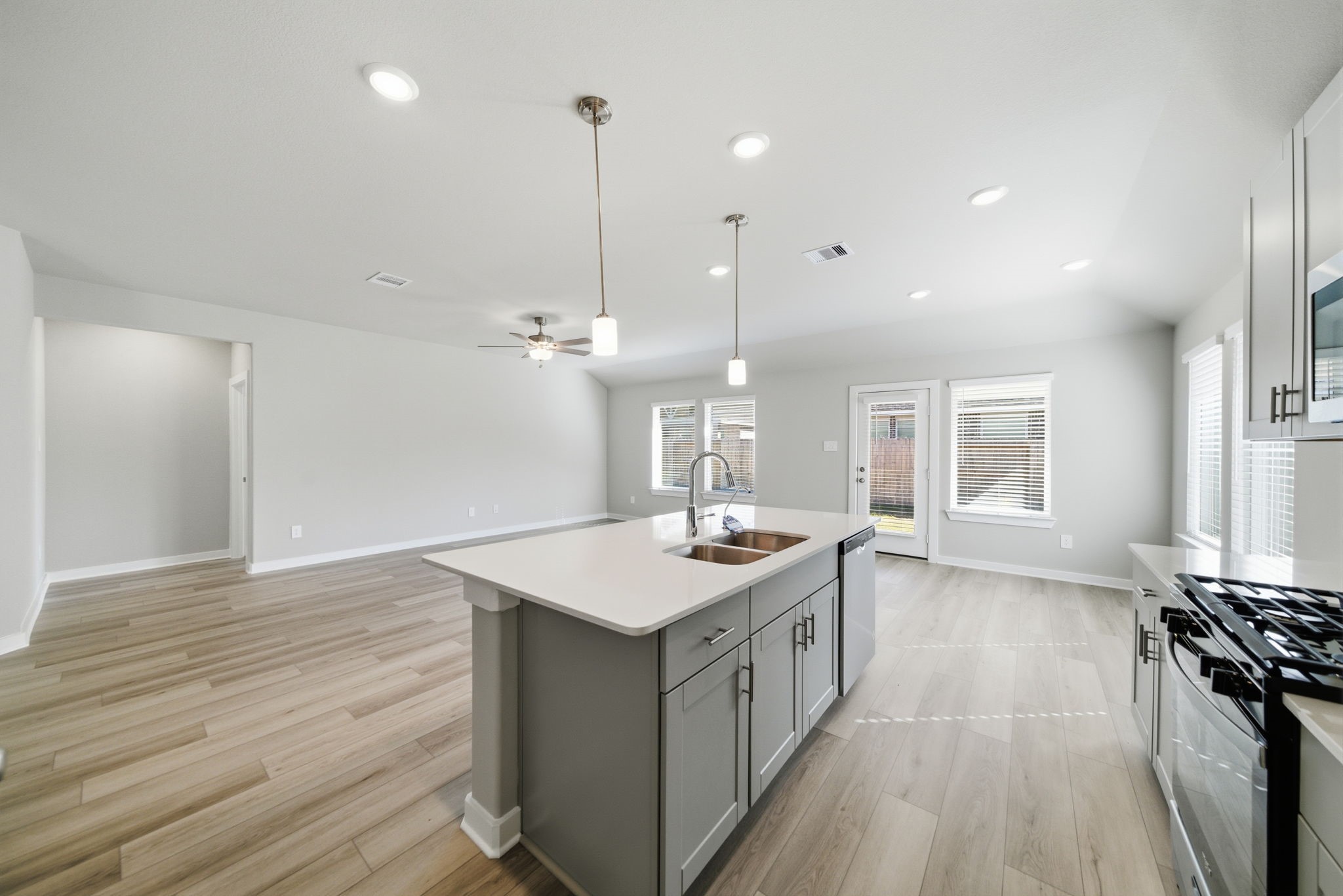 2606 Good Morrow Drive Rosenberg, TX 77471 - Photo 9 of 23 a kitchen with a stove sink and wooden floor