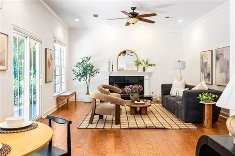 a living room with furniture fireplace and a large window