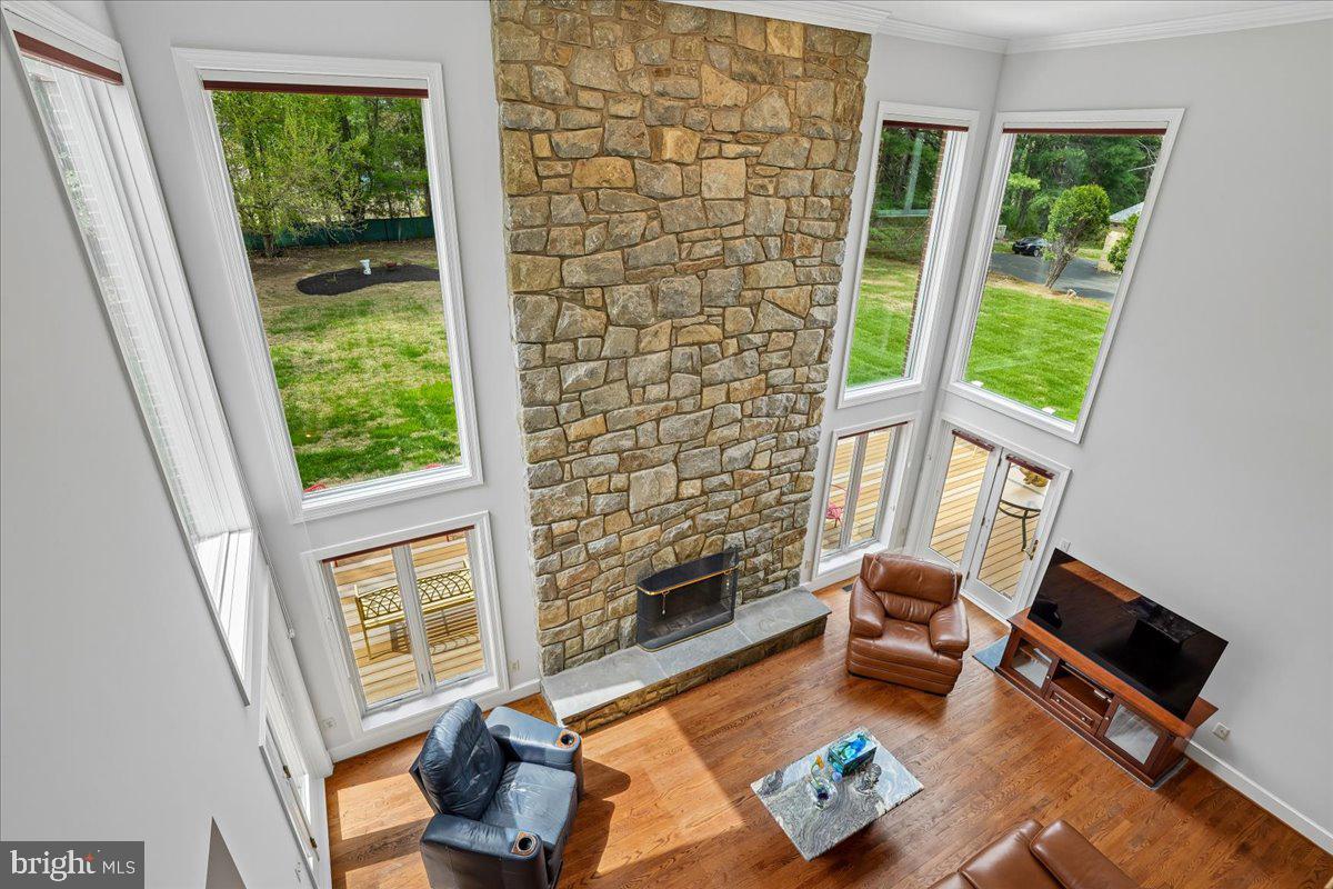 12640 Travilah Road Potomac, MD 20854 - Photo 23 of 56 Stone fireplace framed by windows and family room