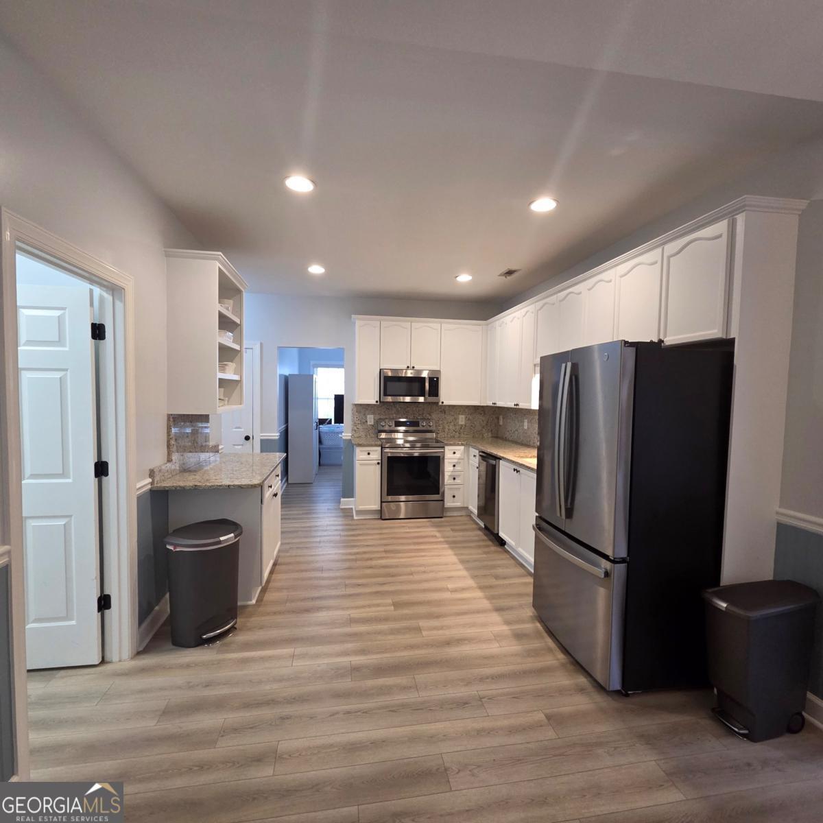 105 Cottage Grove Peachtree City, GA 30269 - Photo 3 of 13 a kitchen with stainless steel appliances granite countertop a refrigerator stove and oven