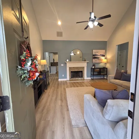 a living room with furniture a fireplace and a chandelier
