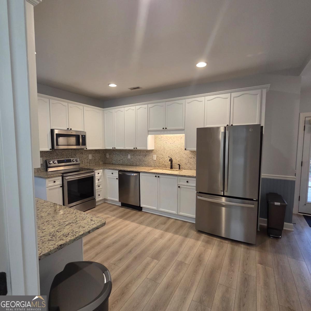 105 Cottage Grove Peachtree City, GA 30269 - Photo 7 of 13 a kitchen with granite countertop a refrigerator oven a sink and dishwasher
