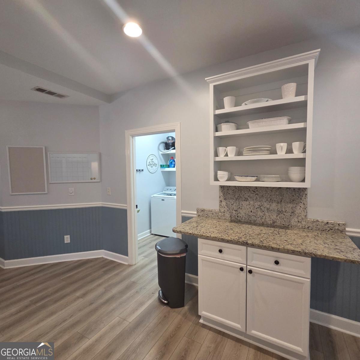 105 Cottage Grove Peachtree City, GA 30269 - Photo 8 of 13 a kitchen with a sink cabinets and wooden floor