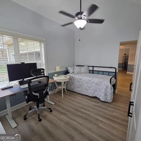 a bedroom with a bed and a desk